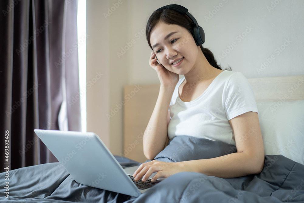 Beautiful Asian young woman using laptop computer to brows the internet and social media. Beautiful Asian young woman using laptop computer to brows the internet and social media.