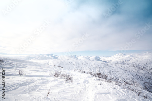 Winter landscape. Snow covered mountains covered with snow against blue sky. Kamchatka peninsula, Russia
