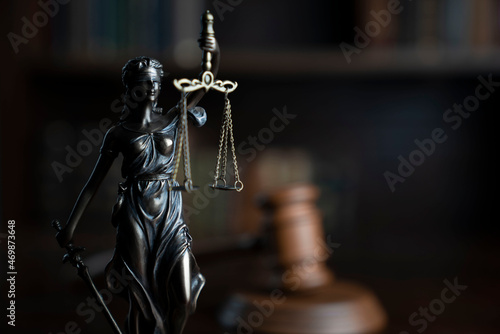 Law theme. Judge chamber. Judge’s gavel, Themis sculpture and collection of legal books.