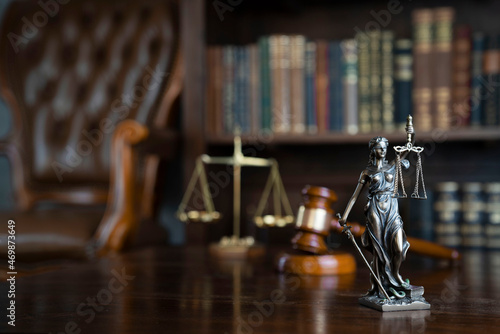 Law theme. Judge chamber. Judge’s gavel, Themis sculpture and collection of legal books.