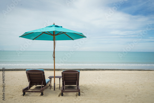 Beach with sunbed and Blue umbrella. © papzi