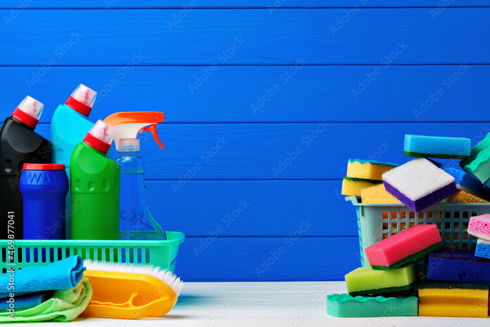 Various cleaning items against blue wooden background Various cleaning items against blue wooden background