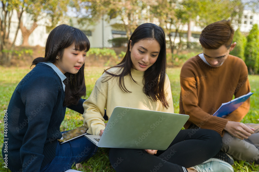 Group Teen asian student working with computer laptop outdoor university campus green park concept Group Teen asian student working with computer laptop outdoor university campus green park concept
