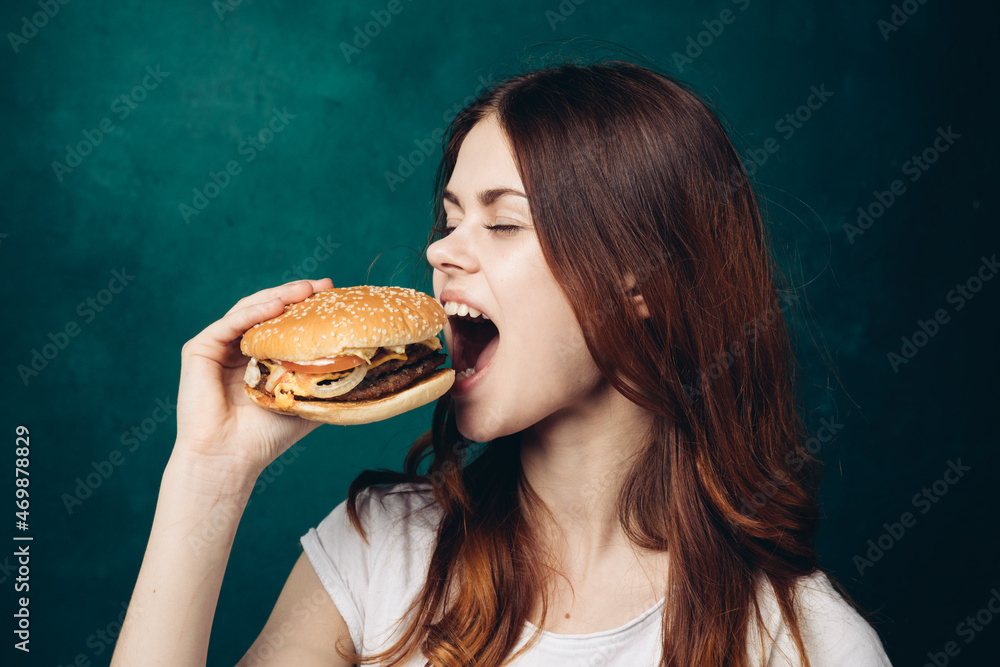 cheerful woman eating hamburger snack close-up lifestyle cheerful woman eating hamburger snack close-up lifestyle