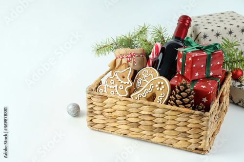 Concept of gift with Christmas basket on white background