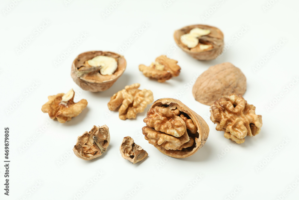 Walnuts with nutshell on white background, close up Walnuts with nutshell on white background, close up