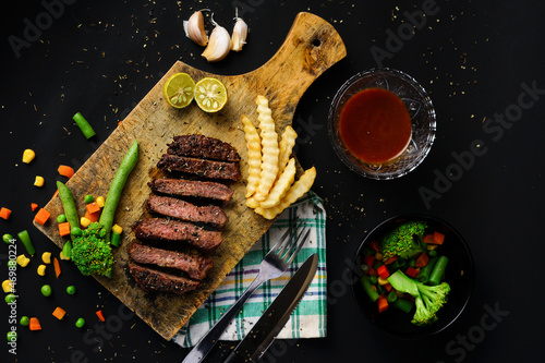 Beef steak slices with bbq sauce and vegetables
