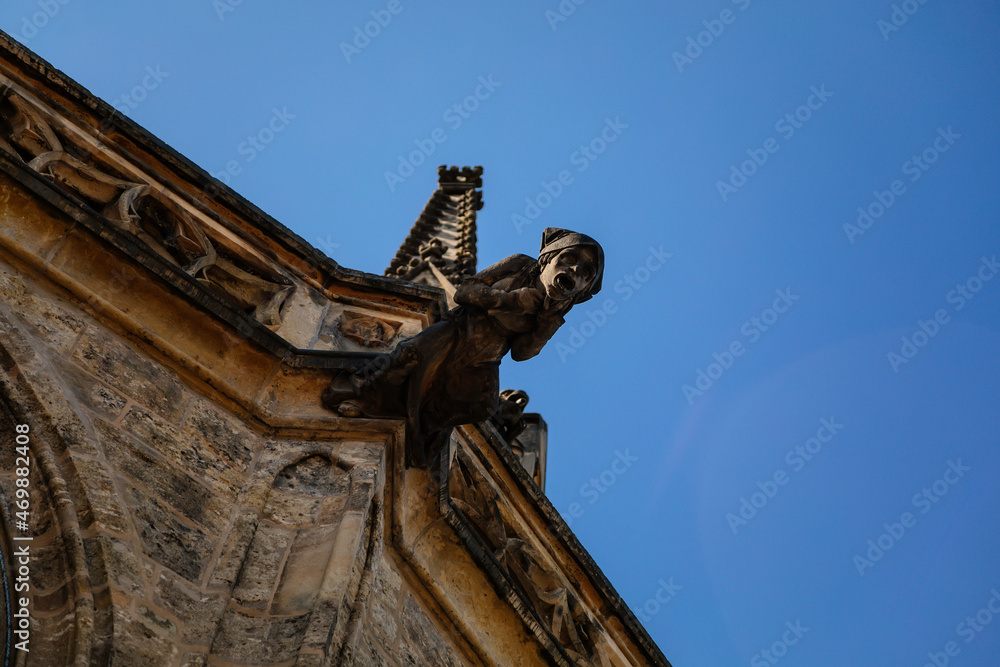 Kolin, Central Bohemia, Czech Republic, 10 July 2021: Low angle view at a part of Medieval stone St. Bartholomew´s Church in autumn day, arched windows, chimeras and gargoyles, Gothic Cathedral