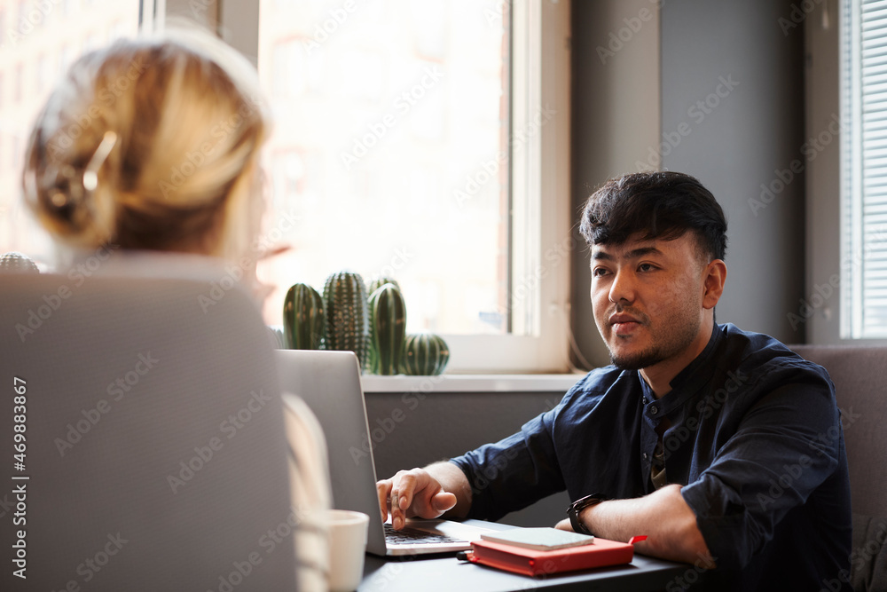 Coworkers talking in office Coworkers talking in office