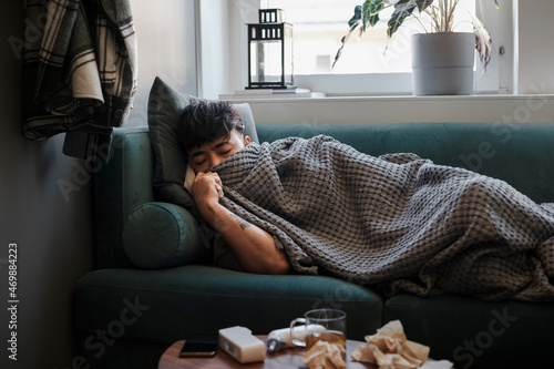 Ill man sleeping on sofa