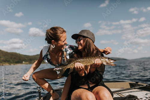Happy women holding fish