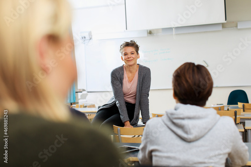 Teacher giving lecture in classroom photo