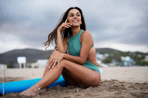 Young happy woman with surfboard. Hot sexy girl preparing for the surf. Beautiful woman enjoy in sunny day.