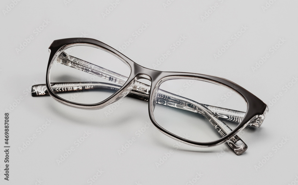 Glasses for the eyesight, on a gray background. Glasses in a modern style. Glasses with clear lenses. Fashionable accessories. Glasses for the eyesight, on a gray background. Glasses in a modern style. Glasses with clear lenses. Fashionable accessories.