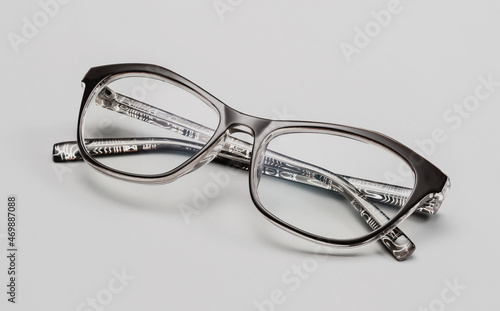 Glasses for the eyesight, on a gray background. Glasses in a modern style. Glasses with clear lenses. Fashionable accessories.