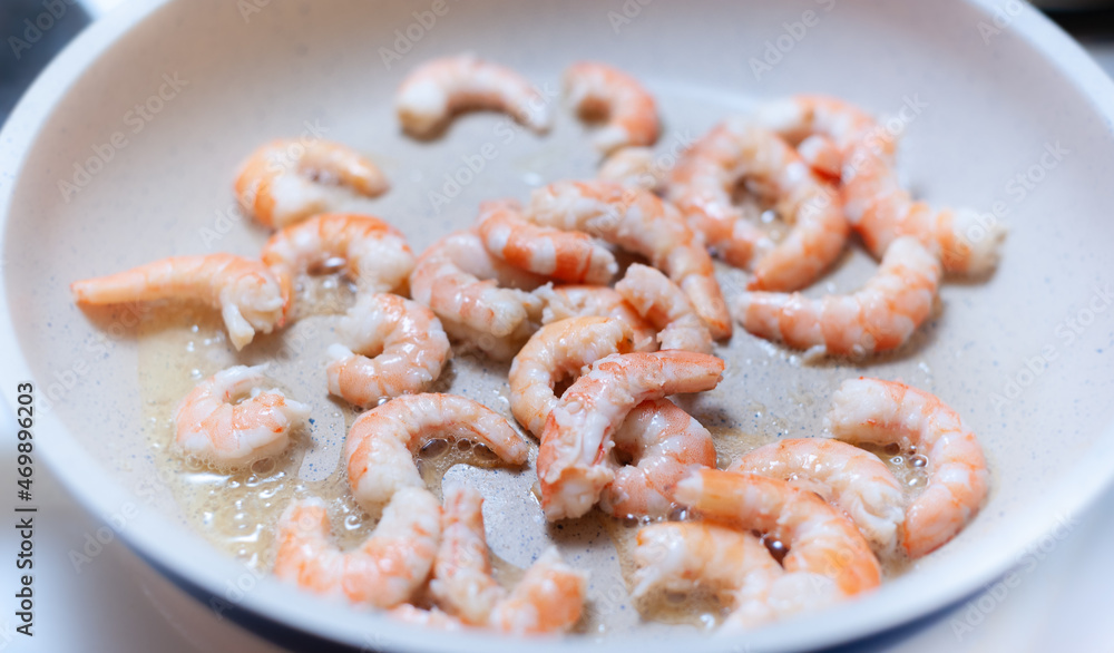 Shrimp fried in a white ceramic pan Shrimp fried in a white ceramic pan