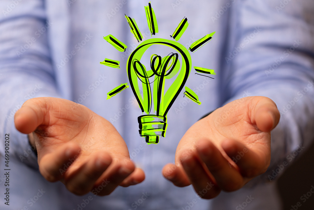 Hands holding green nature in the light bulb Hands holding green nature in the light bulb