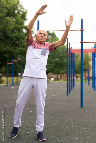 Fitness, sport and healthy lifestyle concept — happy senior woman exercising at park
