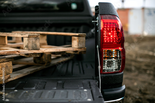 Black car trunk with an open top without a roof in the rain, close-up, shagreen coating.
