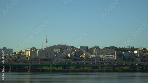 The Yongsan District of Seoul, South Korea and the historic Namsan Tower on a clear day over the Han River photo