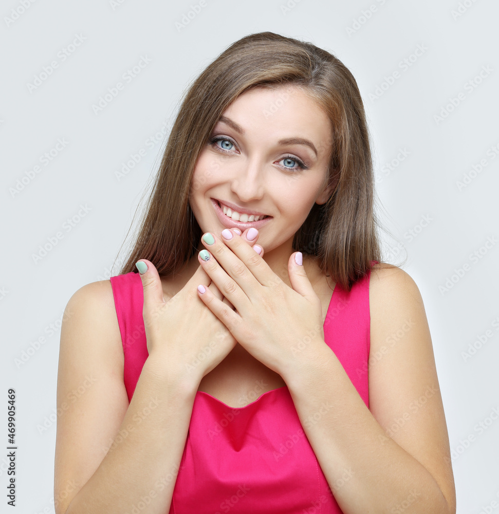 Portrait of young woman covering her face with hands.Girl peeking through fingers Portrait of young woman covering her face with hands.Girl peeking through fingers