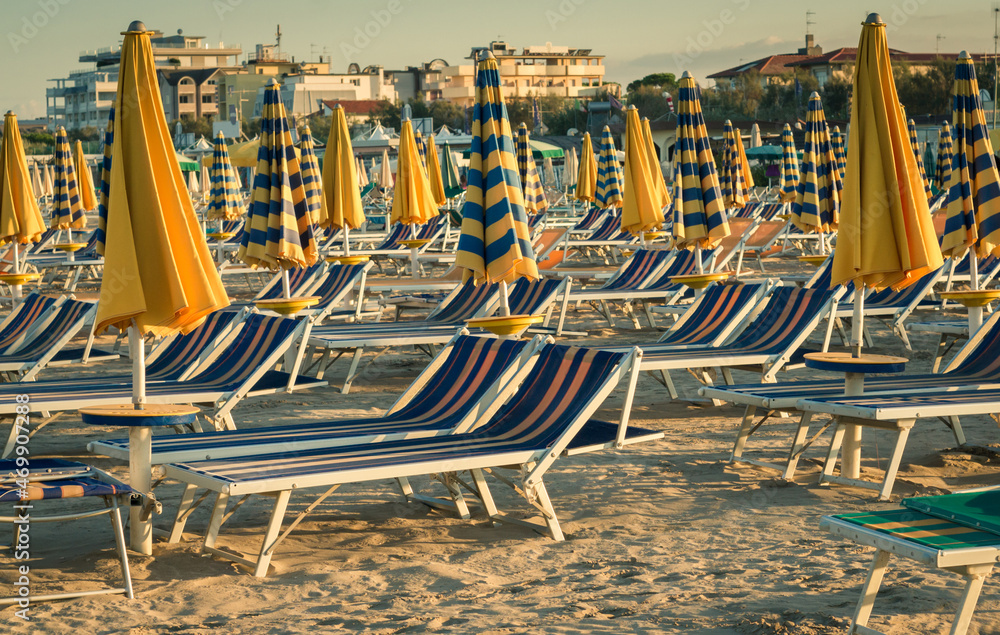 Sun loungers and umbrellas in the early morning Sun loungers and umbrellas in the early morning