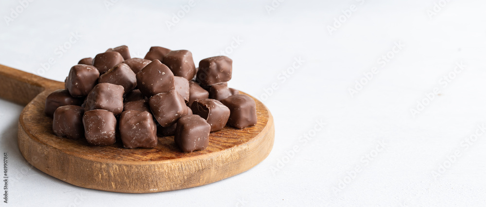 Chocolate covered Turkish delight on a white background. Traditional Turkish cuisine flavor. Empty space for text. Copy space Chocolate covered Turkish delight on a white background. Traditional Turkish cuisine flavor. Empty space for text. Copy space