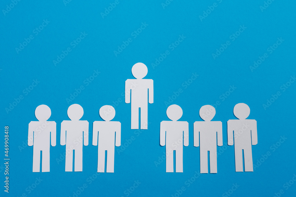 top view of white paper cut people in line near leader isolated on blue, team concept top view of white paper cut people in line near leader isolated on blue, team concept
