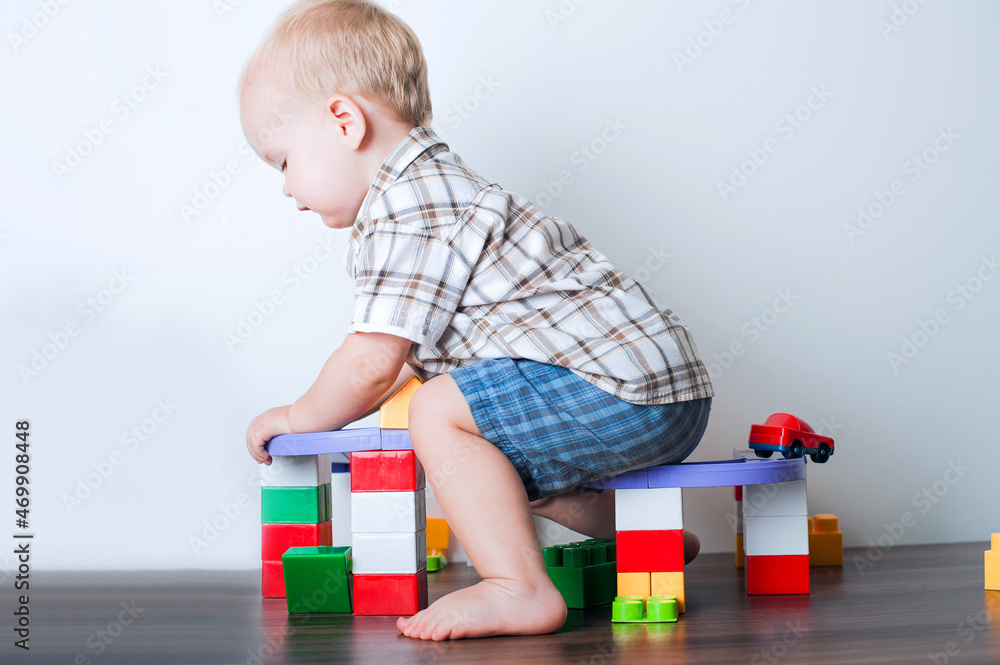 Toddler boy plays with constructor, cars, blocks close-up. Educational toys for preschool children... Toddler boy plays with constructor, cars, blocks close-up. Educational toys for preschool children...