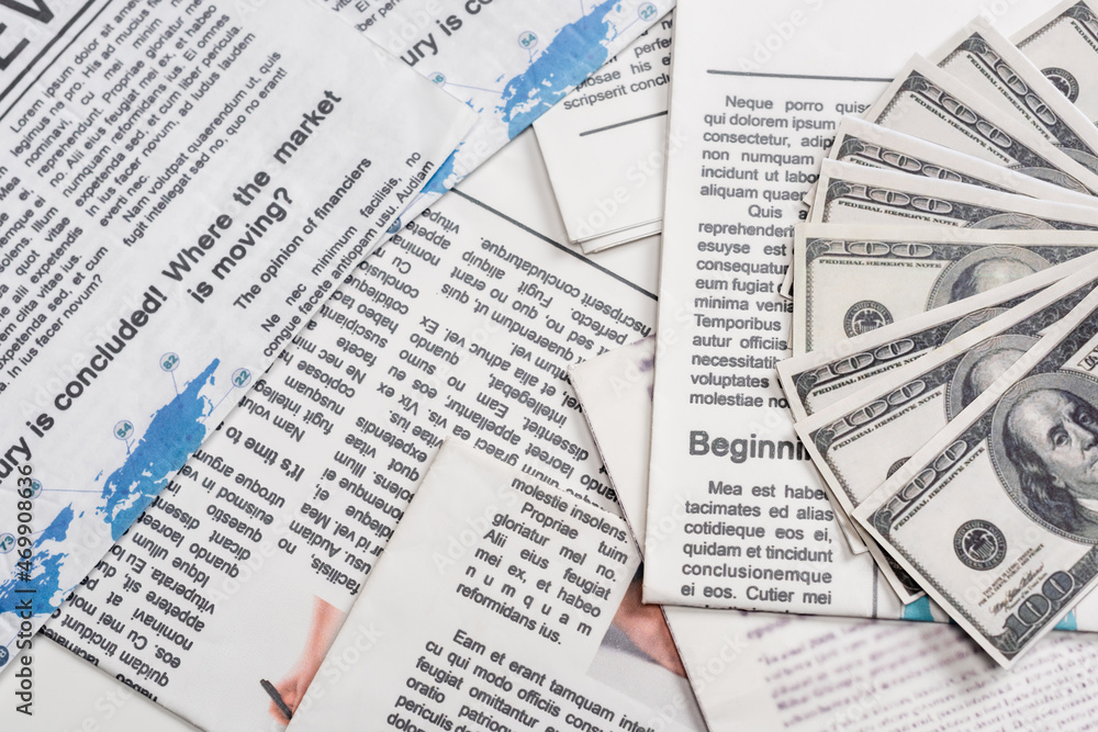 top view of dollar banknotes on newspapers top view of dollar banknotes on newspapers