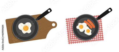 Egg yolk omelet in a skillet. Breakfast in a pan with egg, green peas and sausages.