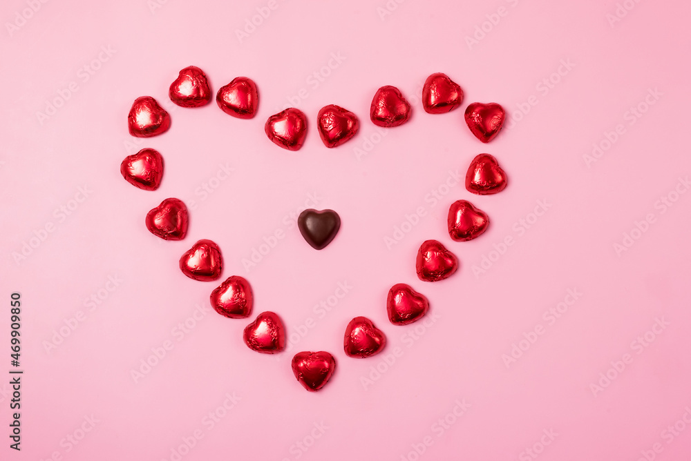 Beautiful Red Chocolate Hearts Candies on Pink Background Valentine Day Holiday Background