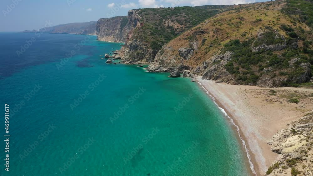 Aerial drone video of small tropical Mediterranean island bay with beautiful turquoise and sapphire clear rocky seascape Aerial drone video of small tropical Mediterranean island bay with beautiful turquoise and sapphire clear rocky seascape