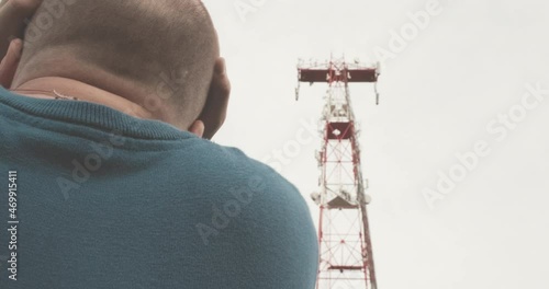 4G and 5G cellular radio tower, the man depicts a strong fright. A parody of the panic around the new 5G towers