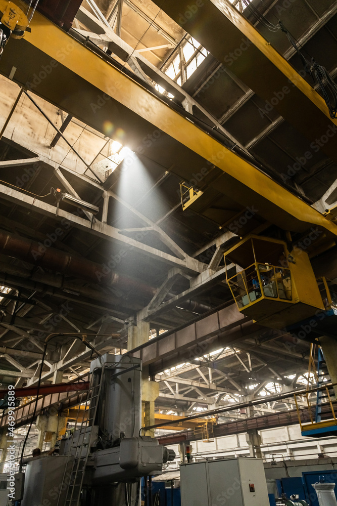 The interior of an old manufacturing plant. Large hangar in a factory with many special machines and technological equipment without people The interior of an old manufacturing plant. Large hangar in a factory with many special machines and technological equipment without people