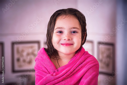Portrait of little girl wearing towel after taking a shower