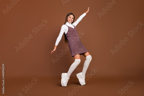 Full length photo of youth cheerful lady have fun playful footwear isolated over brown color background