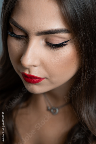 Beautiful young woman with make up and red lips