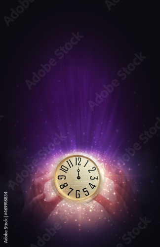 Women's hands are holding an antique clock. Midnight on an antique clock, blurred background. New Year's futuristic background, blurred light lines, bokeh, snowflakes