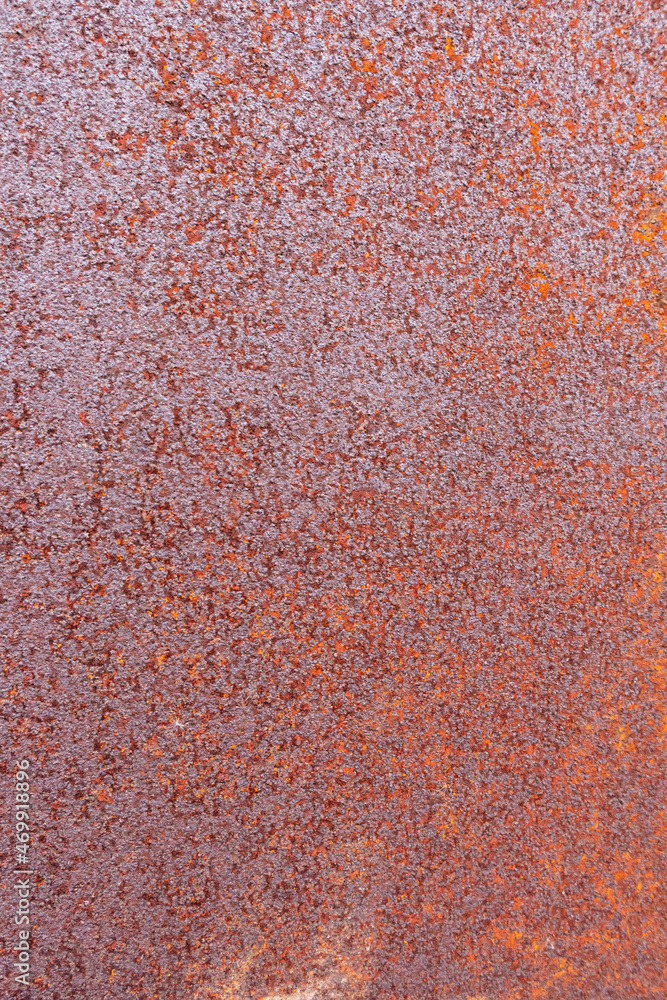 On an ancient iron wall, there is orange rust. On an ancient iron wall, there is orange rust.