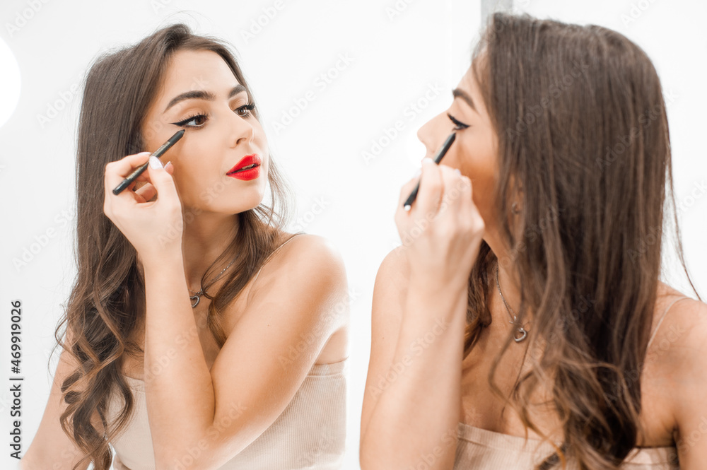 Makeup artist applies lips pencil . Beautiful woman face. Hand of visagiste, painting cosmetics of young beauty model girl . Make up in process Makeup artist applies lips pencil . Beautiful woman face. Hand of visagiste, painting cosmetics of young beauty model girl . Make up in process