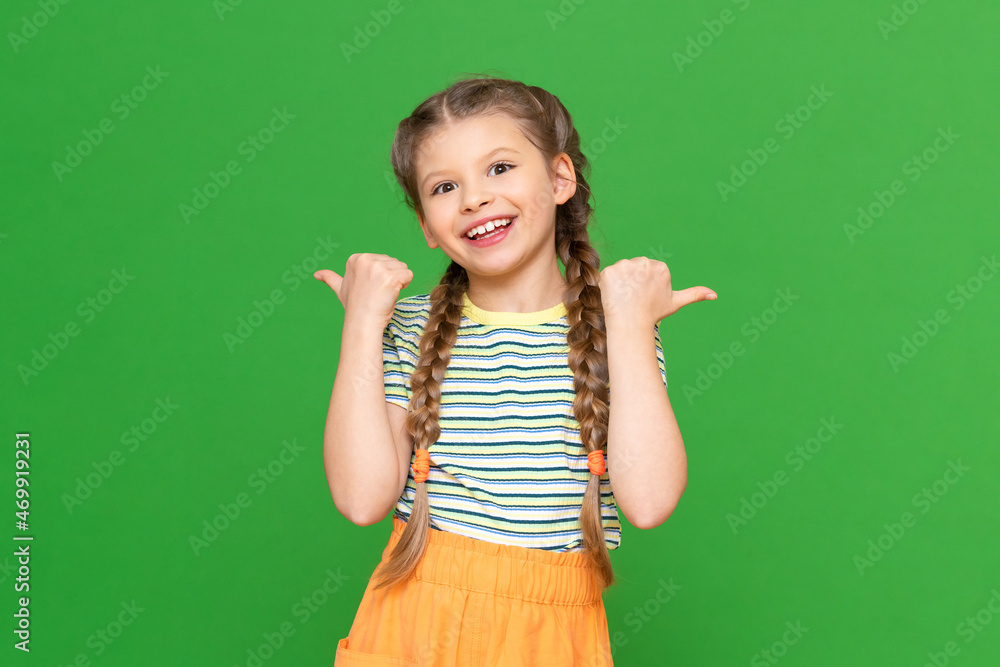 Child points his fingers in different directions, the little girl points at the advertisement. Isolated background. Copy space. Child points his fingers in different directions, the little girl points at the advertisement. Isolated background. Copy space.
