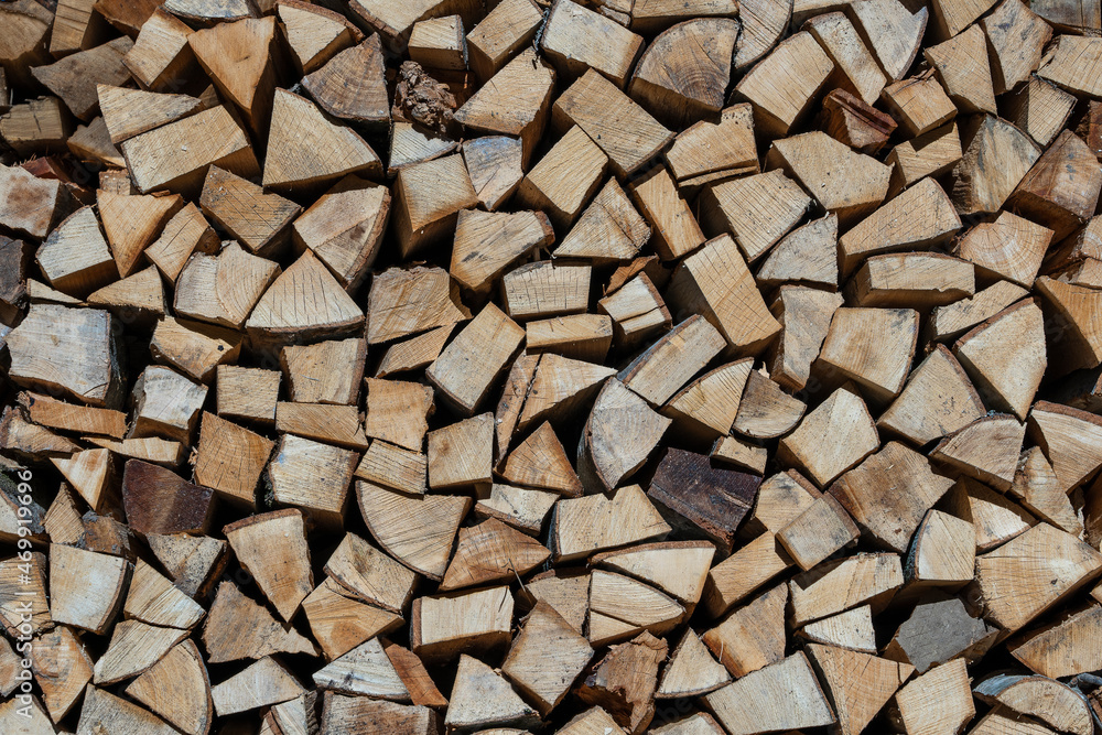 Stack of firewood, wooden abstract background, close up