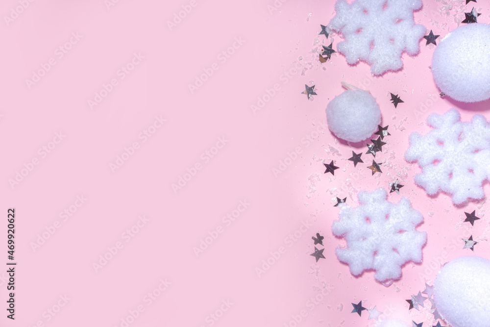 Fluffy Christmas concept. Festive Christmas background with fluffy decoration stuff, xmas ball, gift boxes, with artificial snow and shiny stars on pink color background copy space