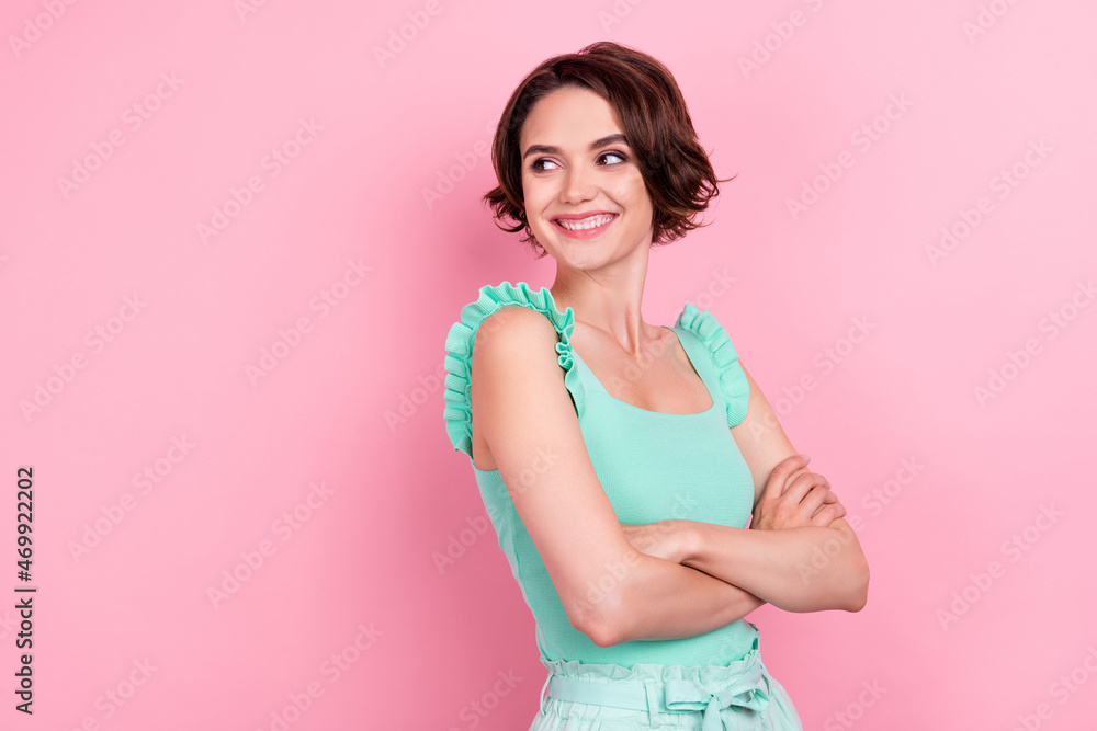 Photo of sweet shiny young lady wear teal singlet arms crossed looking empty space isolated pink color background Photo of sweet shiny young lady wear teal singlet arms crossed looking empty space isolated pink color background