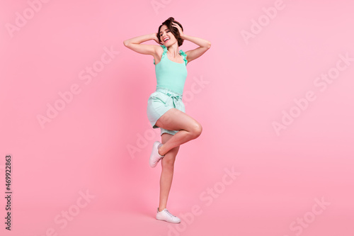 Full length body size view of attractive cheerful dreamy girl dancing having fun clubbing isolated over pink pastel color background