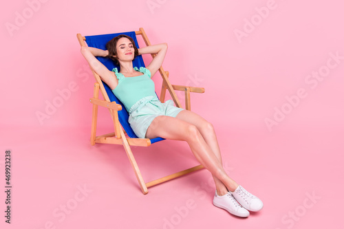 Full length body size view of attractive dreamy girl resting in chair free time isolated over pink pastel color background #469923238