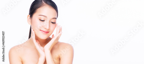 Beauty, cosmetics, healthy, treatment, skincare and spa concept. Asian young woman touching own face with clear fresh skin. Teenager with perfect treatment skin over isolated white background.