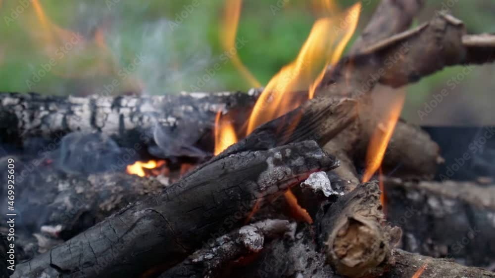 A burning fire with coals in close-up. Burning coals, flaming particles flying off. Slow motion A burning fire with coals in close-up. Burning coals, flaming particles flying off. Slow motion