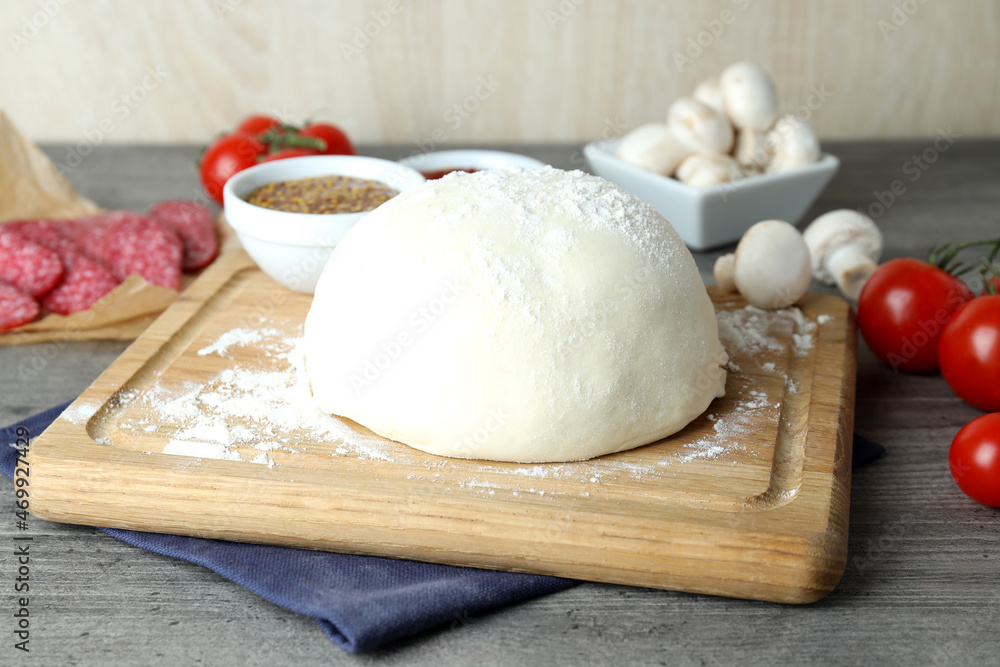 Concept of cooking pizza on gray wooden table Concept of cooking pizza on gray wooden table